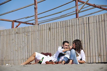 Image showing young couple enjoying  picnic on the beach