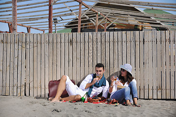 Image showing young couple enjoying  picnic on the beach