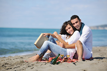 Image showing young couple enjoying  picnic on the beach