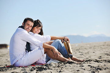 Image showing young couple enjoying  picnic on the beach