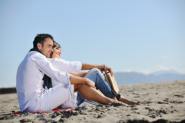 Image showing young couple enjoying  picnic on the beach