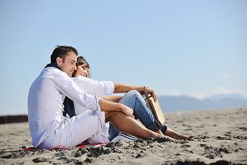 Image showing young couple enjoying  picnic on the beach