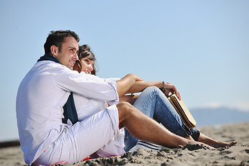 Image showing young couple enjoying  picnic on the beach