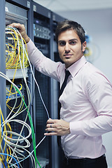 Image showing young it engeneer in datacenter server room