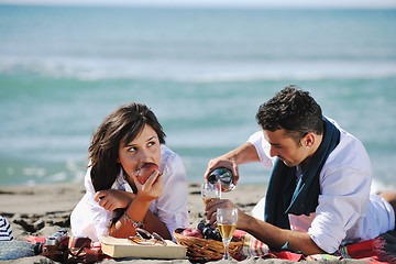 Image showing young couple enjoying  picnic on the beach