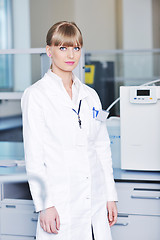 Image showing female researcher holding up a test tube in lab