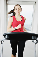 Image showing woman workout  in fitness club on running track 