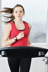 Image showing womanworkout  in fitness club on running track machine 