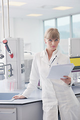 Image showing female researcher holding up a test tube in lab