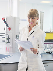 Image showing female researcher holding up a test tube in lab