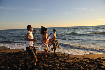 Image showing people group running on the beach