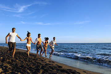 Image showing people group running on the beach