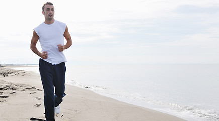 Image showing man running on beach