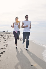 Image showing couple jogging on the beach