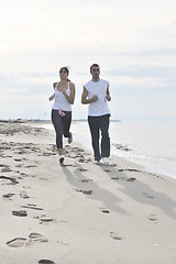 Image showing couple jogging on the beach