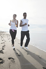 Image showing couple jogging on the beach