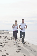 Image showing couple jogging on the beach