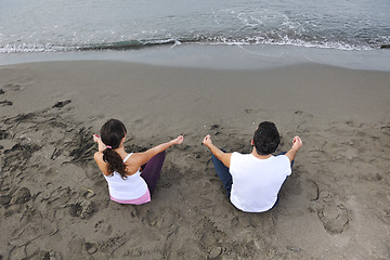 Image showing couple yoga beach