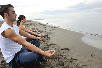 Image showing couple yoga beach