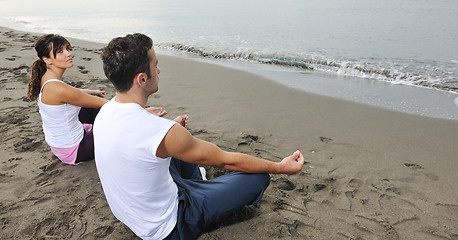 Image showing couple yoga beach