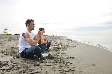 Image showing couple yoga beach