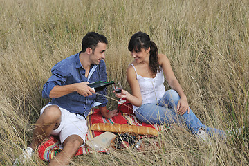 Image showing happy couple enjoying countryside picnic in long grass