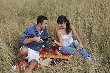 Image showing happy couple enjoying countryside picnic in long grass