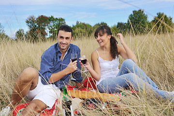 Image showing happy couple enjoying countryside picnic in long grass