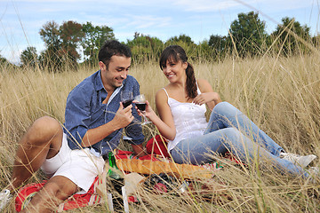 Image showing happy couple enjoying countryside picnic in long grass