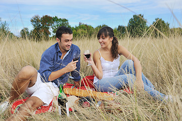 Image showing happy couple enjoying countryside picnic in long grass