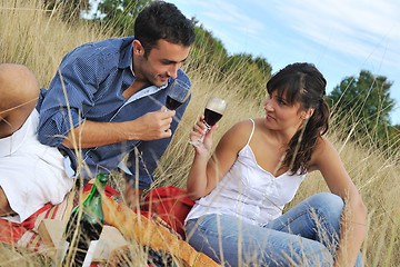 Image showing happy couple enjoying countryside picnic in long grass