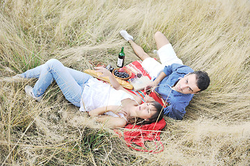 Image showing happy couple enjoying countryside picnic in long grass