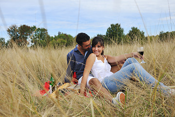 Image showing happy couple enjoying countryside picnic in long grass