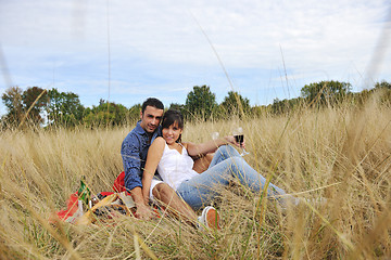 Image showing happy couple enjoying countryside picnic in long grass