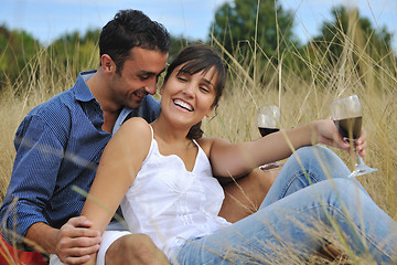 Image showing happy couple enjoying countryside picnic in long grass