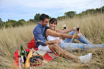 Image showing happy couple enjoying countryside picnic in long grass