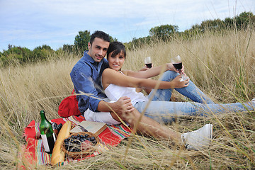 Image showing happy couple enjoying countryside picnic in long grass