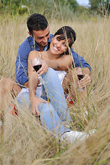 Image showing happy couple enjoying countryside picnic in long grass