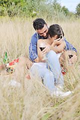 Image showing happy couple enjoying countryside picnic in long grass