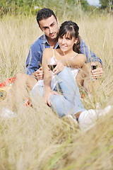 Image showing happy couple enjoying countryside picnic in long grass