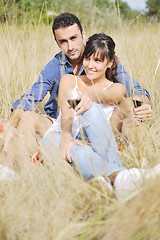 Image showing happy couple enjoying countryside picnic in long grass