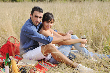 Image showing happy couple enjoying countryside picnic in long grass