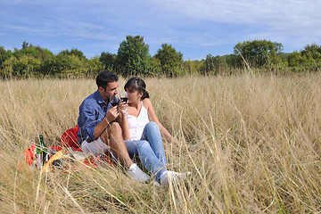 Image showing happy couple enjoying countryside picnic in long grass