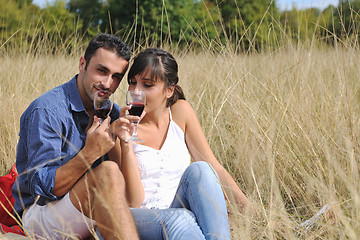 Image showing happy couple enjoying countryside picnic in long grass