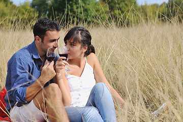 Image showing happy couple enjoying countryside picnic in long grass