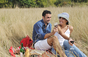 Image showing happy couple enjoying countryside picnic in long grass