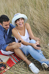 Image showing happy couple enjoying countryside picnic in long grass