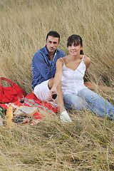 Image showing happy couple enjoying countryside picnic in long grass