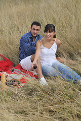 Image showing happy couple enjoying countryside picnic in long grass