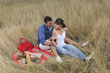 Image showing happy couple enjoying countryside picnic in long grass